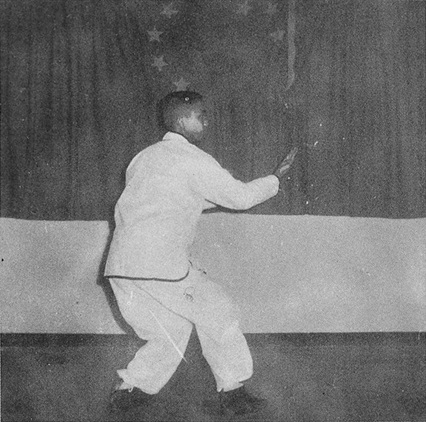 Posture 21, figure A : retrait au pas du milieu, les deux paumes en yin et yang