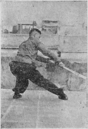 Posture 6b — après le bond vers l&rsquo;ouest, la jambe jetée à droite et le sabre versé au-dessus de la cuisse : figure 6b de l&rsquo;édition de 1955
