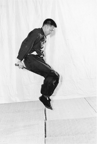 Posture 39 (planche 39) : le saut par-dessus le sabre tenu à l&rsquo;horizontale, les pieds passant de l&rsquo;arrière vers l&rsquo;avant